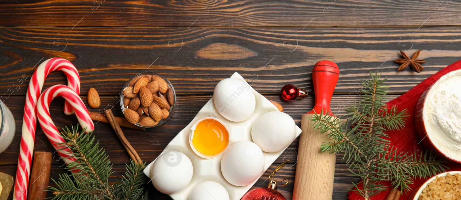 Image of Flat lay composition with ingredients for traditional Christmas cake on wooden table. Banner design 