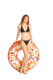 Photo of Beautiful young woman in stylish bikini with doughnut inflatable ring on white background