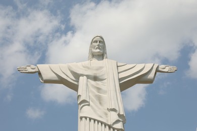 Photo of Truskavets, Ukraine - July 14, 2023: Beautiful statue of Jesus Christ against blue sky, low angle view