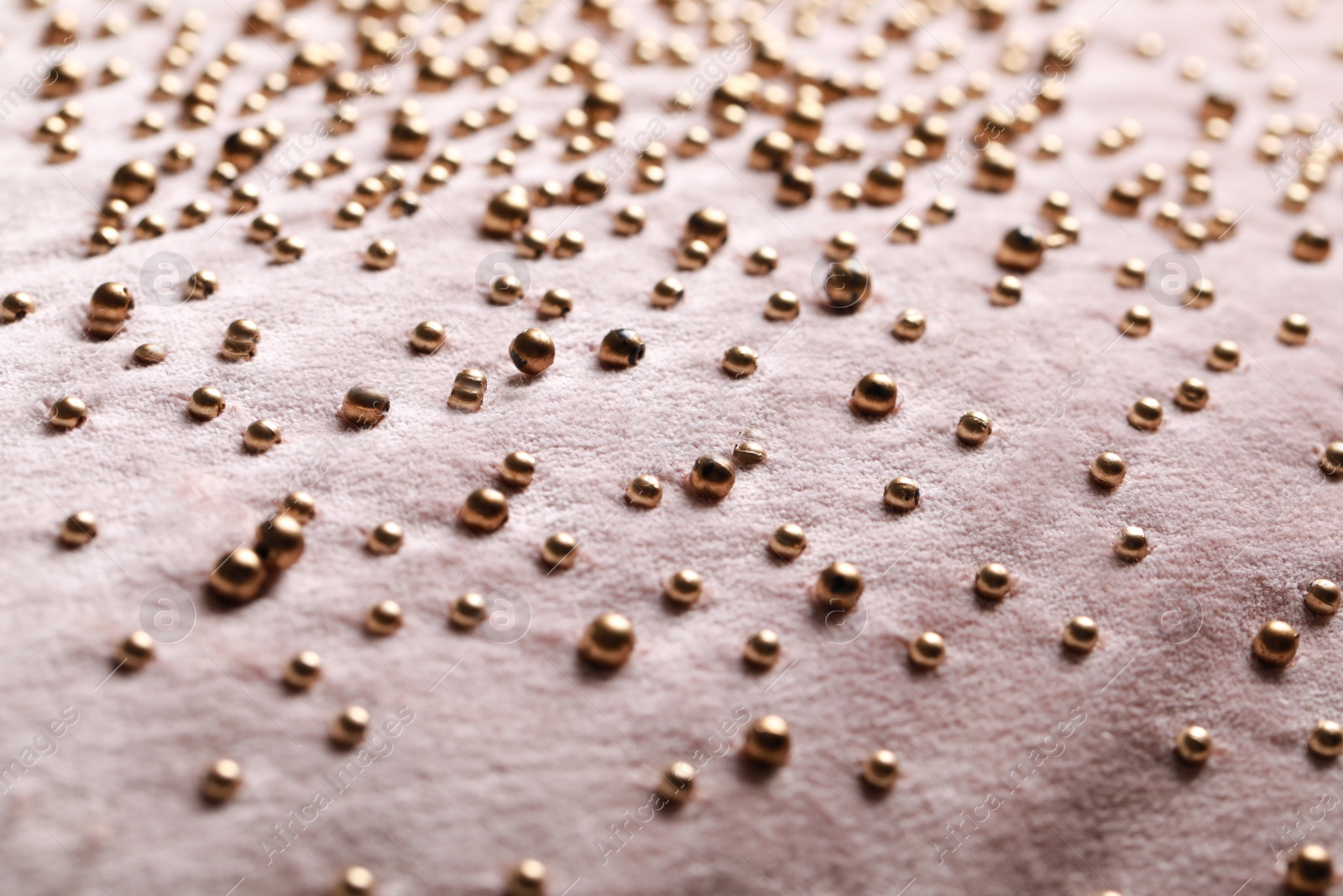 Photo of Beautiful pink fabric with golden beads as background, closeup