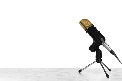 Photo of Microphone on table against white background. Space for text