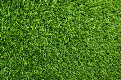 Photo of Green artificial grass as background, top view