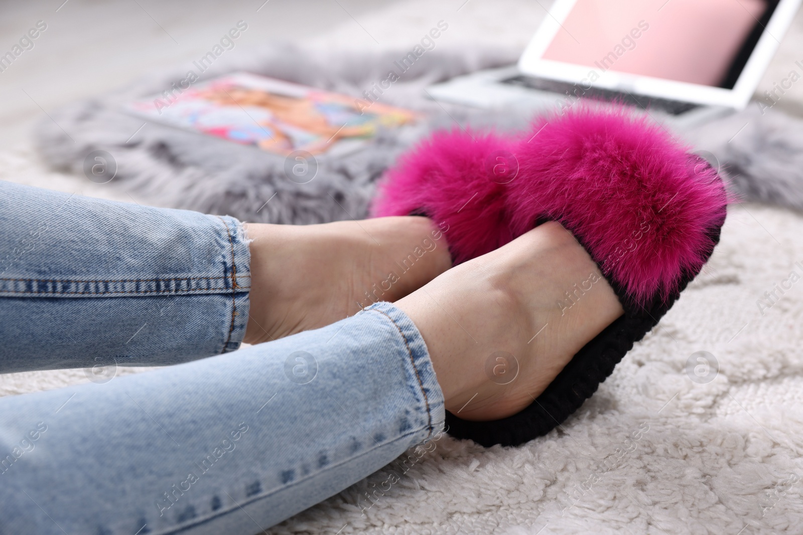 Photo of Woman in soft slippers at home, closeup