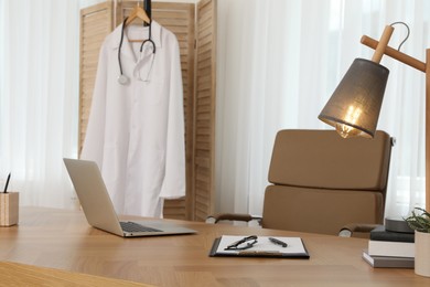 Photo of Modern doctor's workplace in stylish office. Interior design