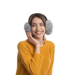 Happy woman wearing warm earmuffs on white background