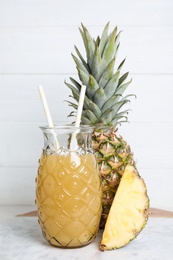 Photo of Freshly made pineapple juice on white table