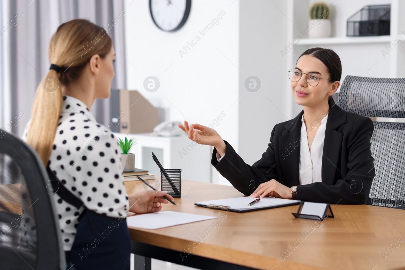 Photo of Injured woman having meeting with lawyer in office