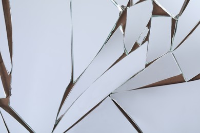 Shards of broken mirror on backing board, top view