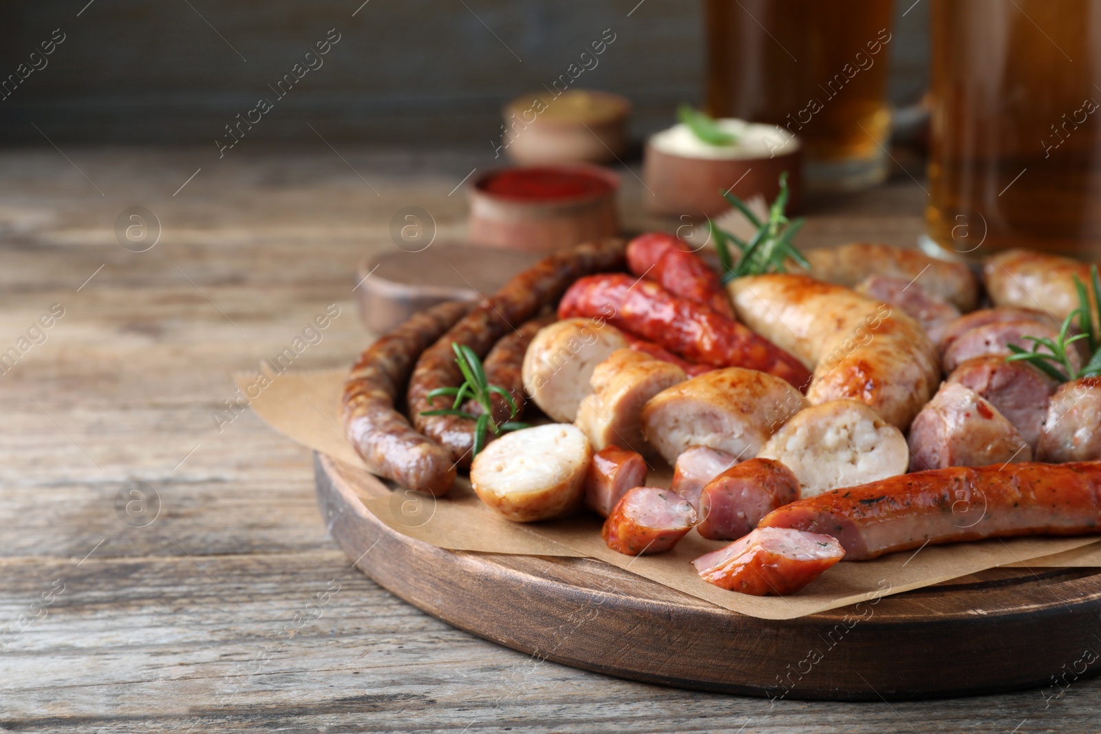 Photo of Set of different tasty snacks and beer on wooden table, closeup view. Space for text
