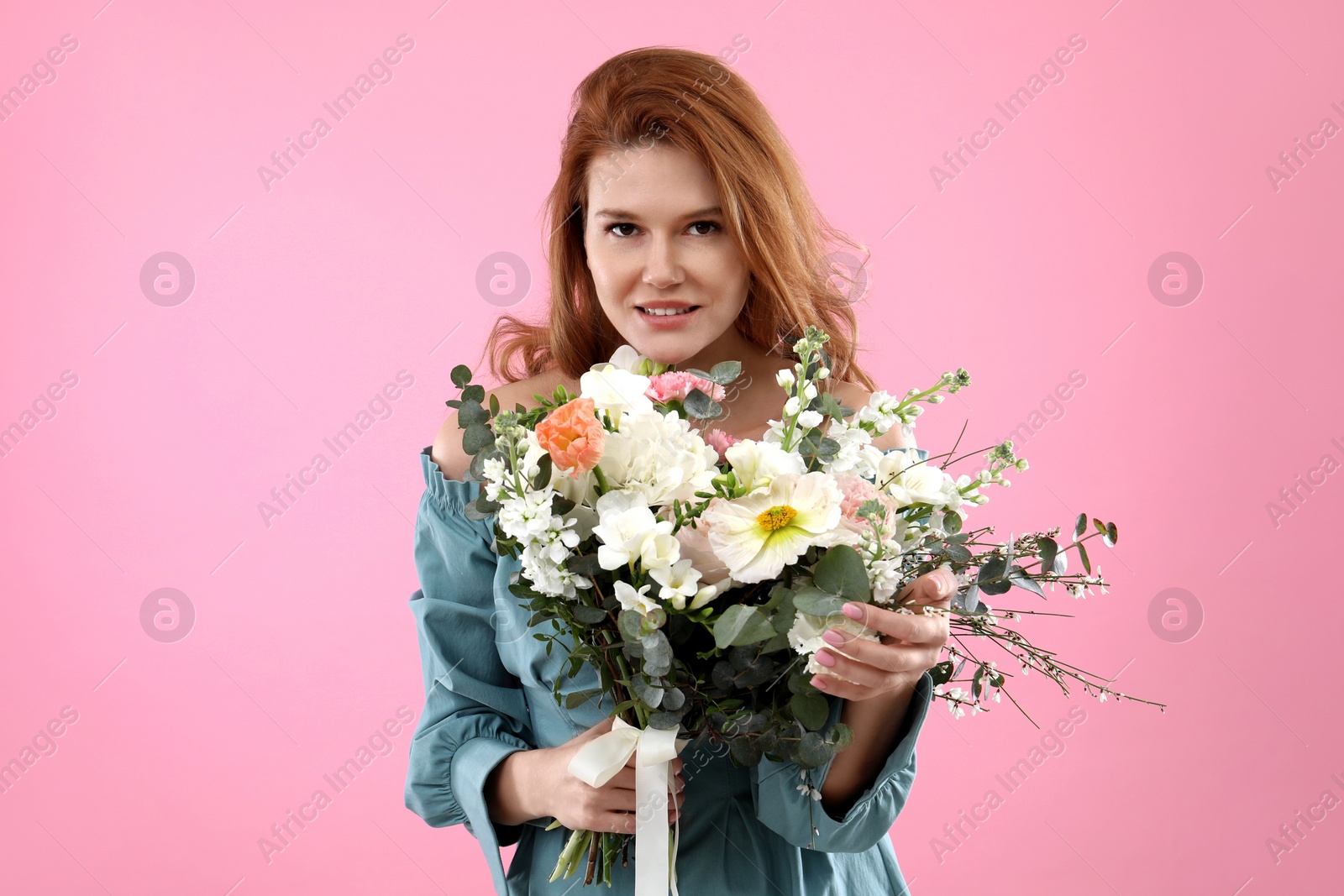 Photo of Beautiful woman with bouquet of flowers on pink background