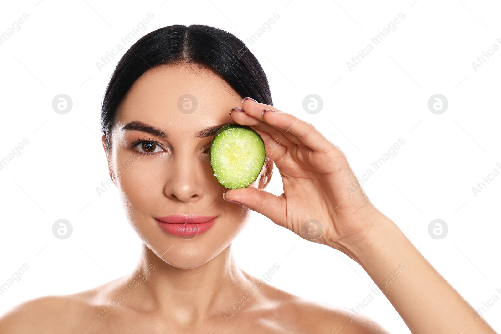 Photo of Young woman with silky skin after face mask holding cucumber on white background