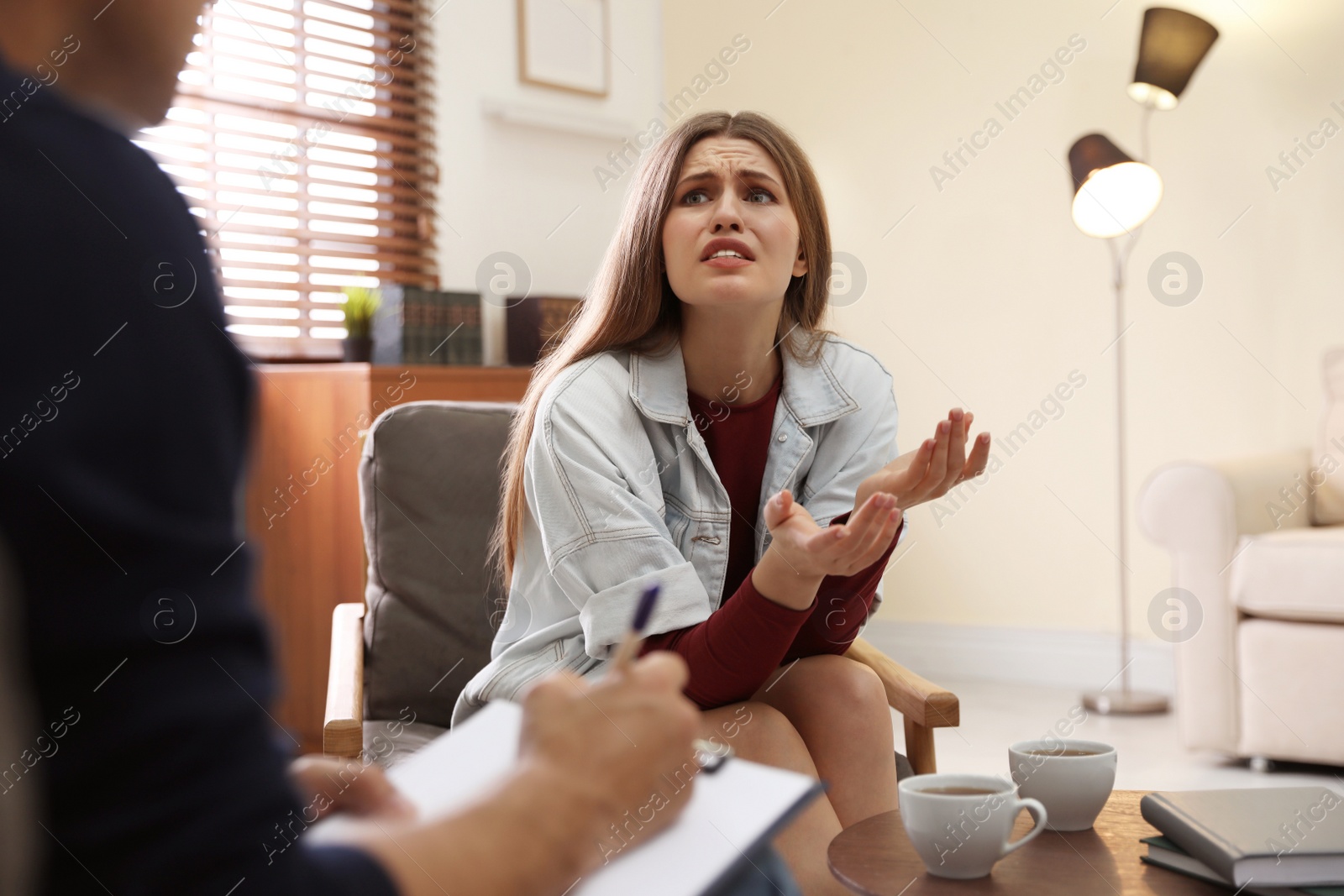 Photo of Professional psychotherapist working with patient in office