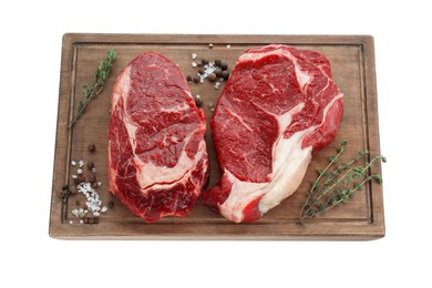 Photo of Pieces of fresh beef meat, thyme and spices on white background, top view