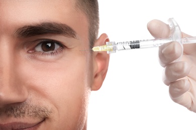 Photo of Man getting facial injection on white background, closeup. Cosmetic surgery