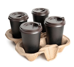 Photo of Takeaway paper coffee cups in cardboard holder on white background