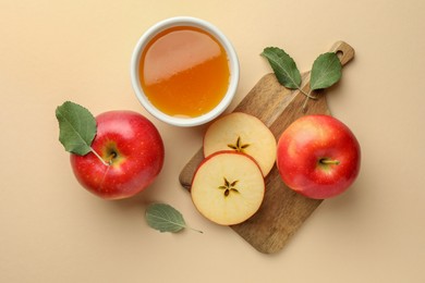 Photo of Delicious apples, bowl of honey and leaves on beige background, flat lay