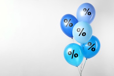 Image of Discount offer. Balloons with percent sign on white background, space for text
