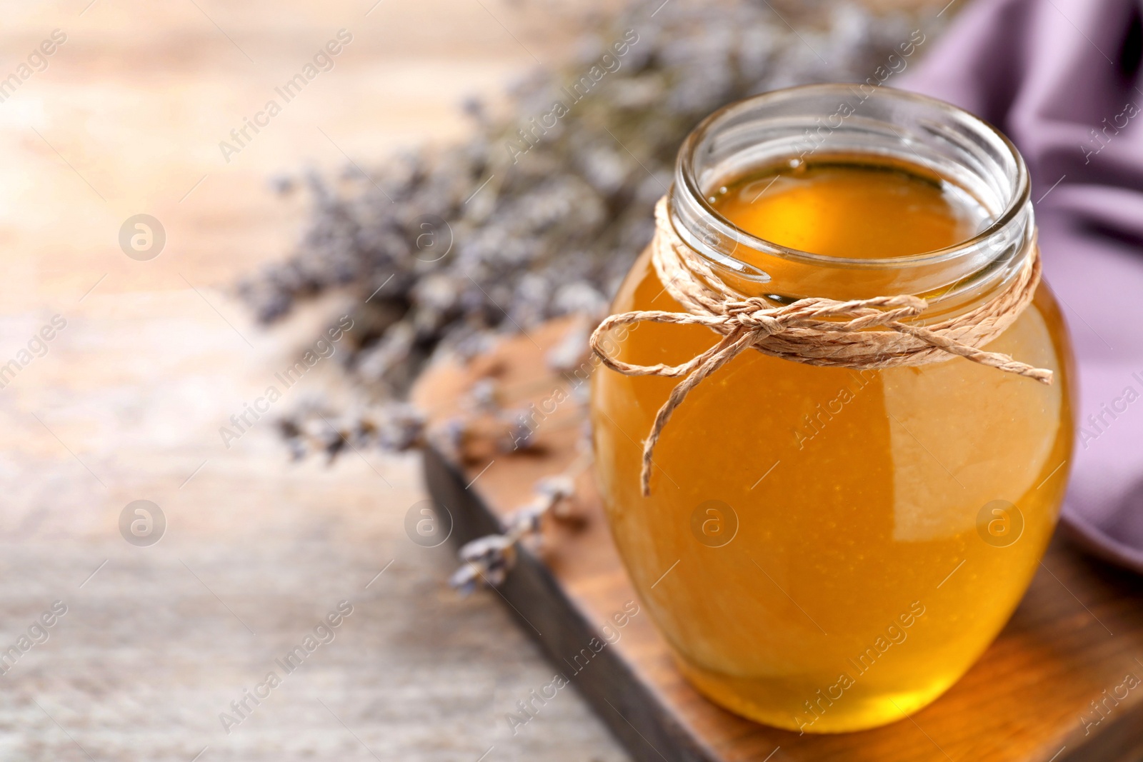 Photo of Tasty fresh sunflower honey on table, closeup