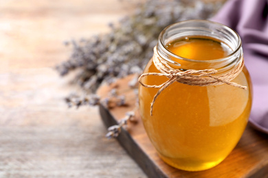 Photo of Tasty fresh sunflower honey on table, closeup