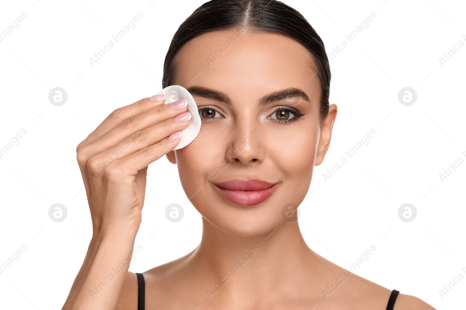 Photo of Beautiful woman removing makeup with cotton pad on white background