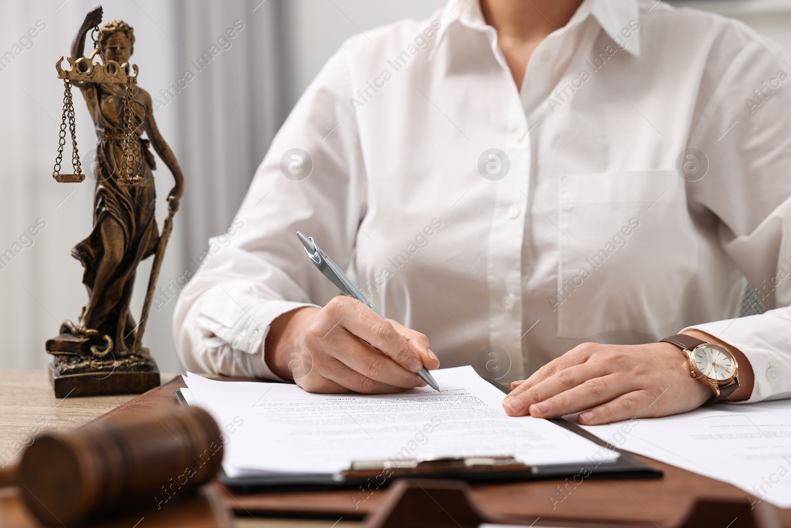 Photo of Lawyer working with documents at table in office, closeup