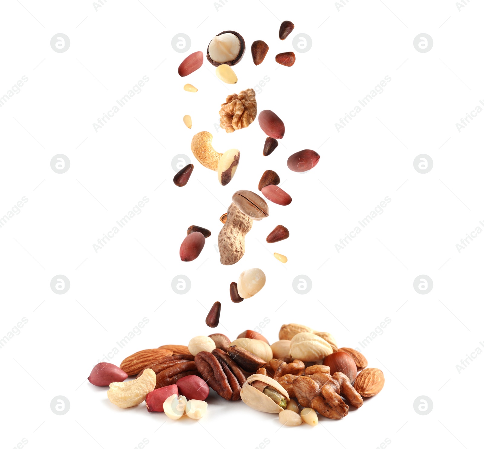 Image of Different nuts falling into pile on white background 