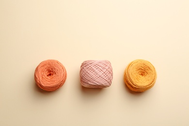 Photo of Clews of knitting threads on color background, flat lay. Sewing stuff