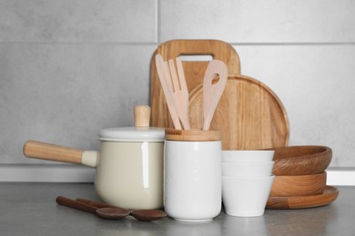 Cooking utensils and other kitchenware on grey countertop