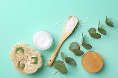 Jar of cream, body care products and eucalyptus branch on turquoise background, flat lay