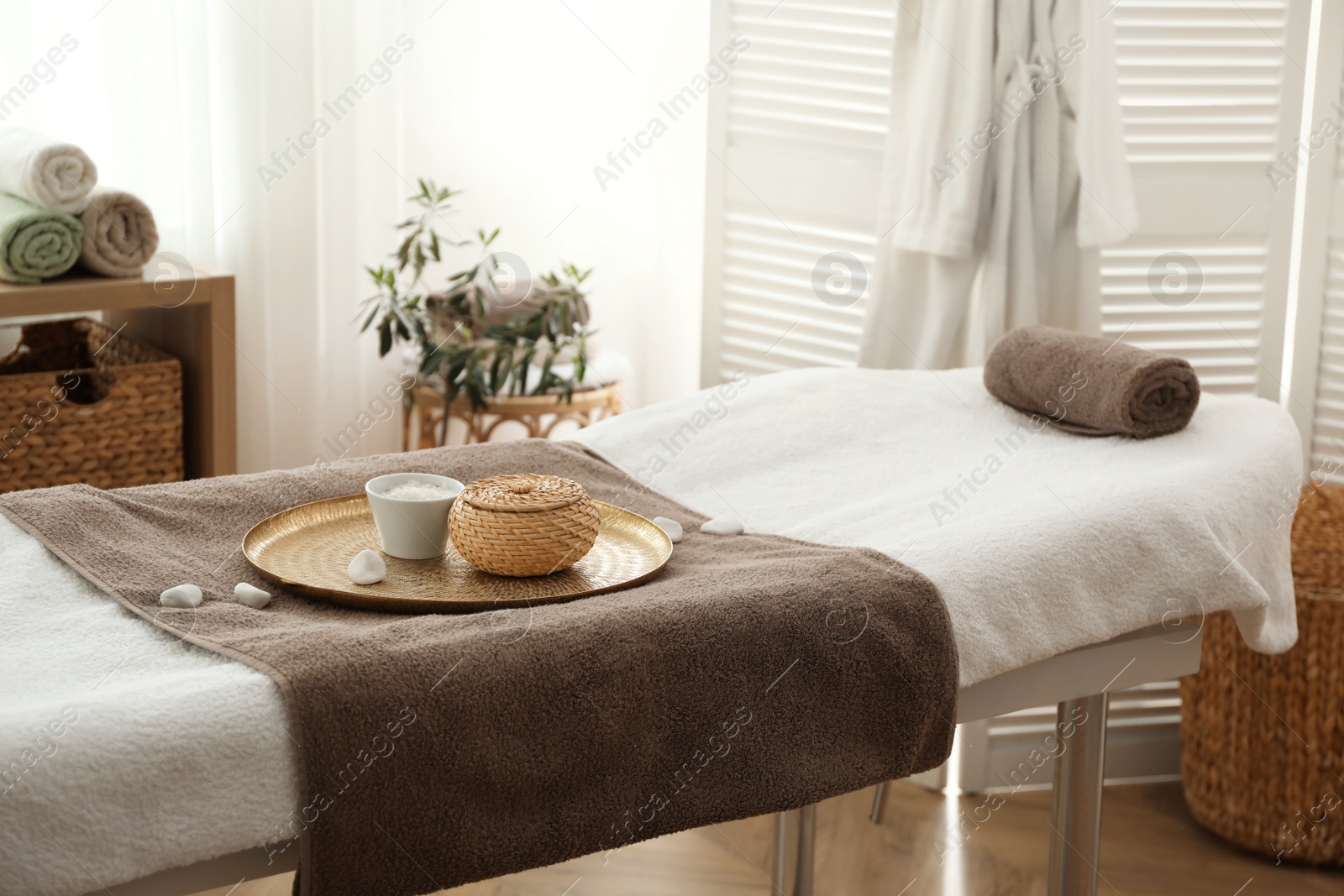 Photo of Stylish room interior with massage table in spa salon