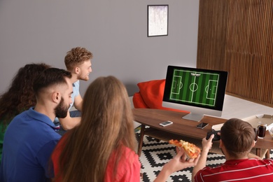 Group of friends playing video games at home