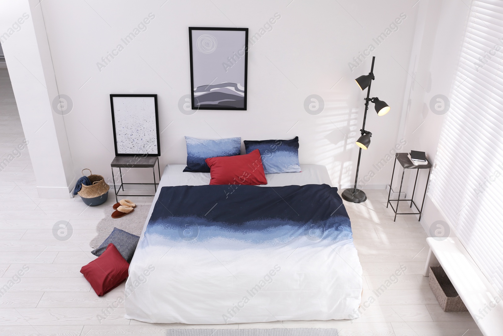 Photo of Large bed with stylish linens in room, above view