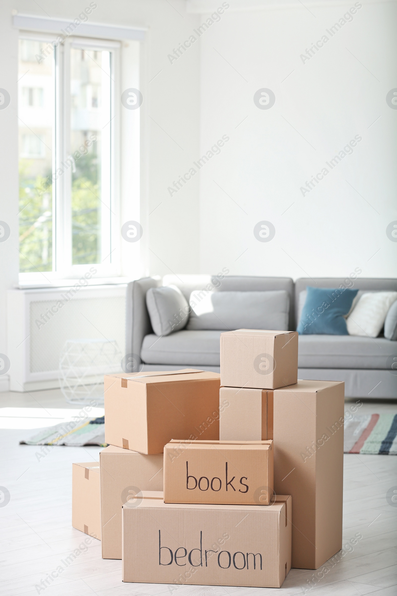 Photo of Pile of moving boxes in living room
