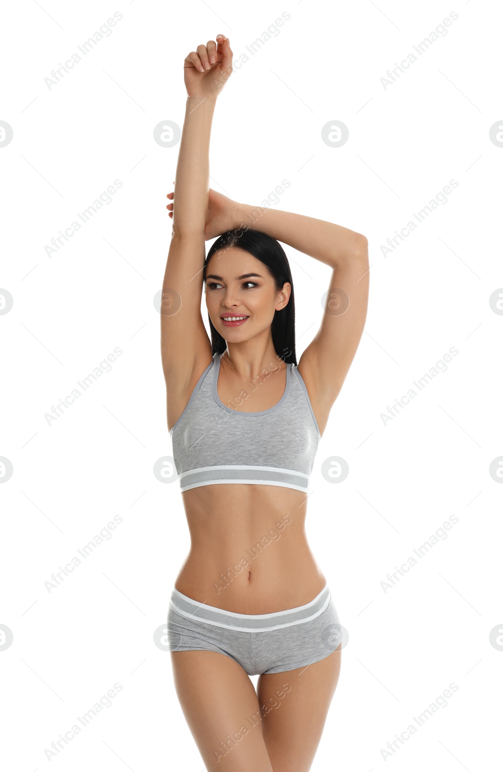 Photo of Beautiful young woman in grey sportive underwear isolated on white