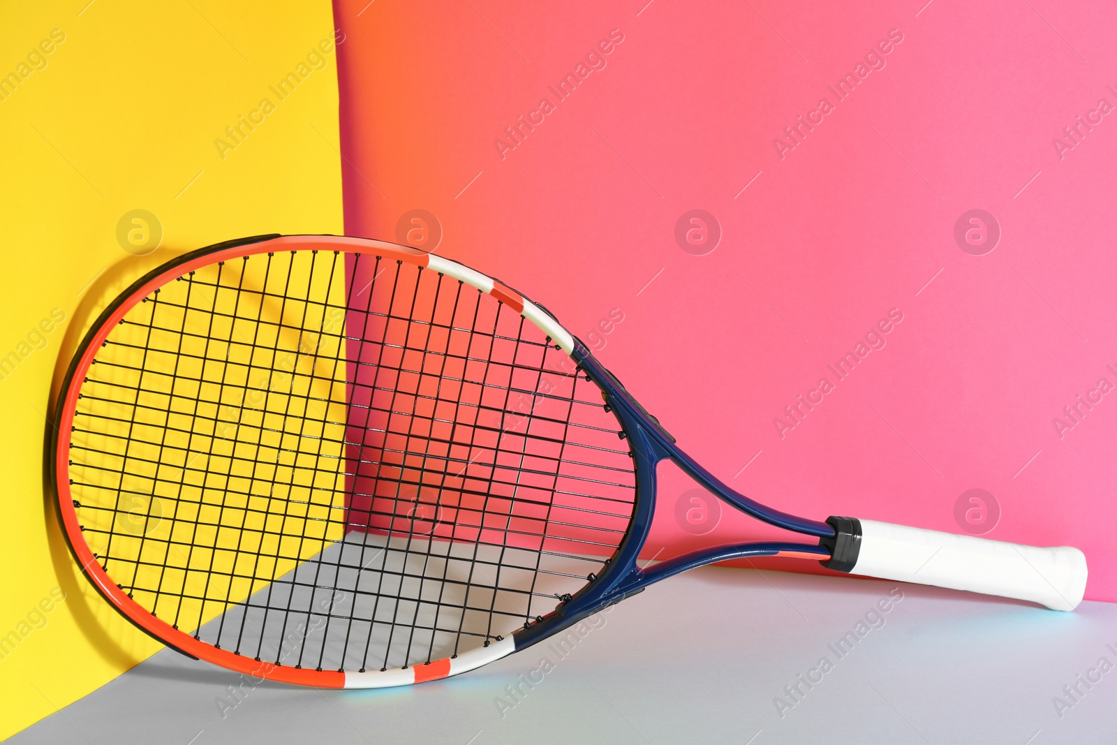 Photo of Tennis racket on color background. Sports equipment