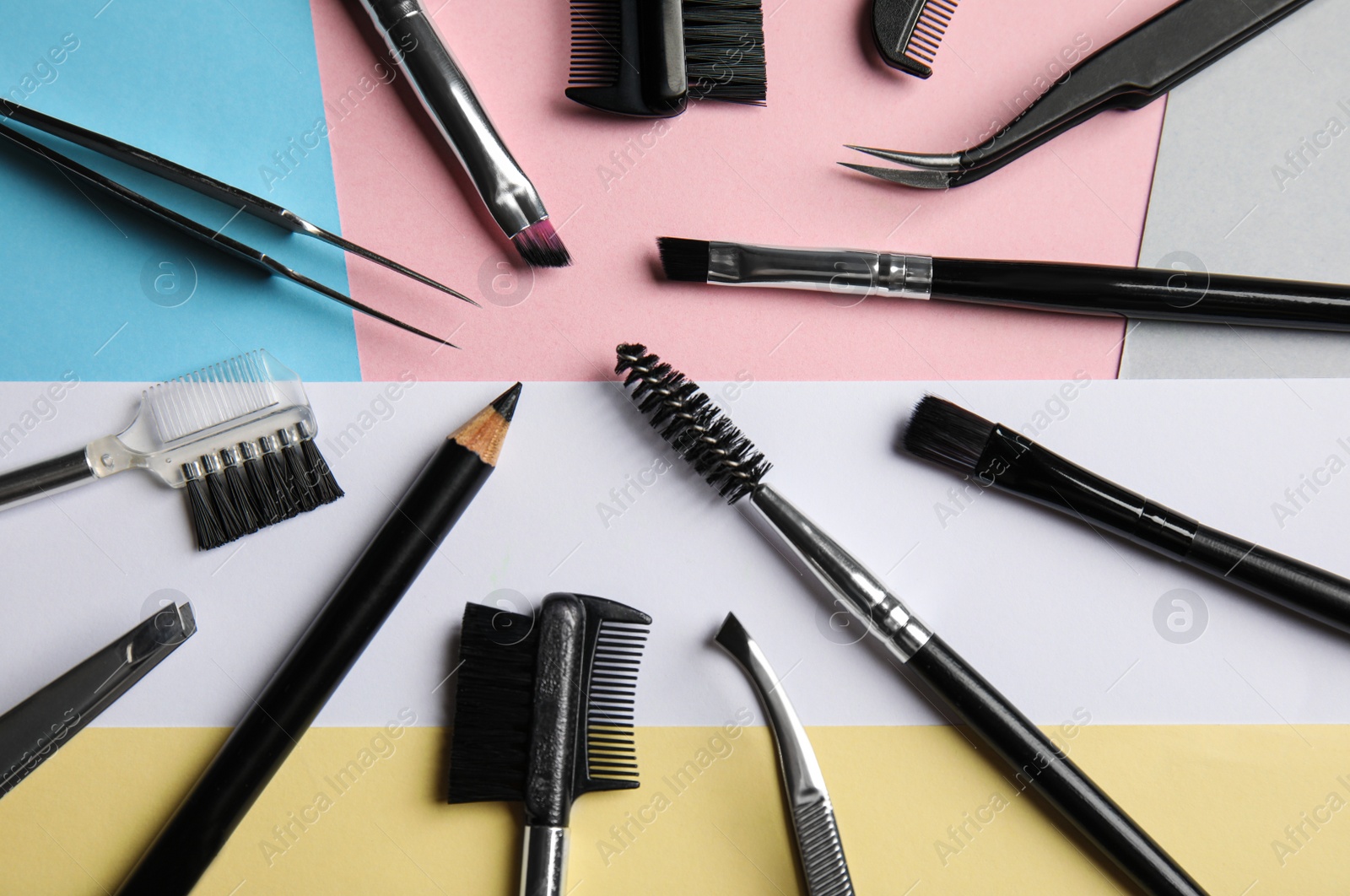 Photo of Set of professional eyebrow tools on color background, flat lay