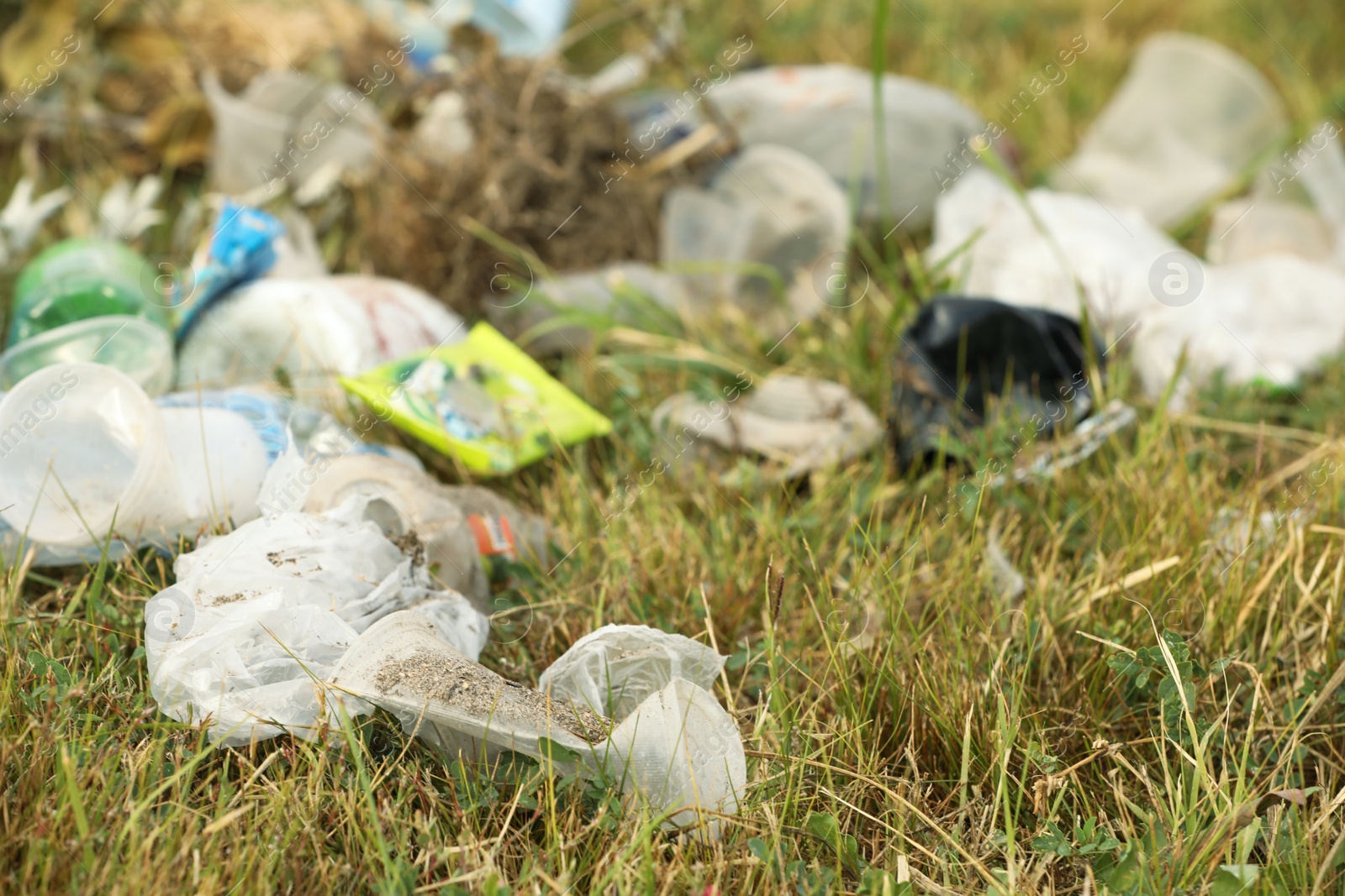 Photo of Garbage scattered on grass. Environment pollution problem