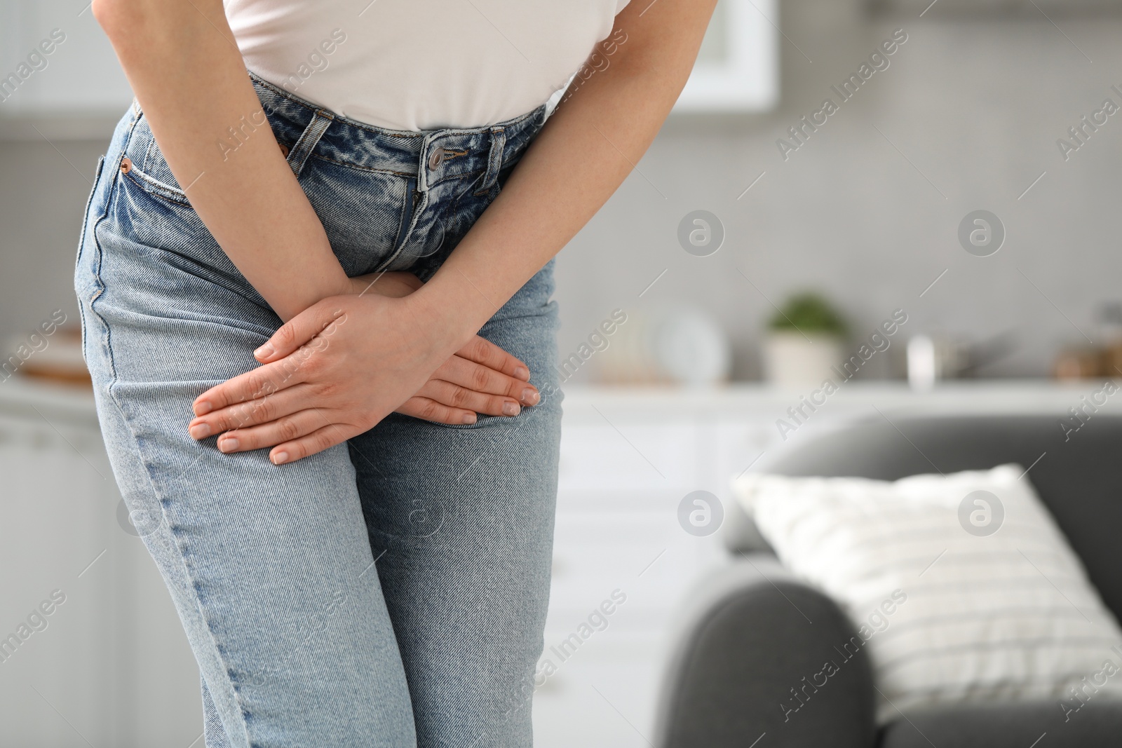 Photo of Woman suffering from cystitis at home, closeup. Space for text