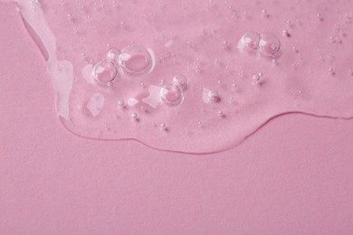 Photo of Cosmetic serum on pink background, closeup. Space for text