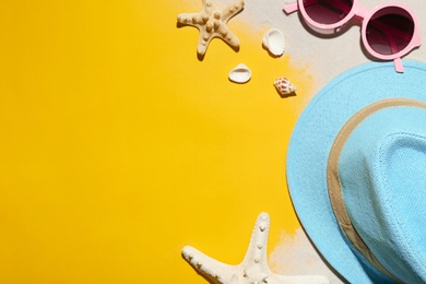 Photo of Flat lay composition with beach objects, sand and space for text on color background