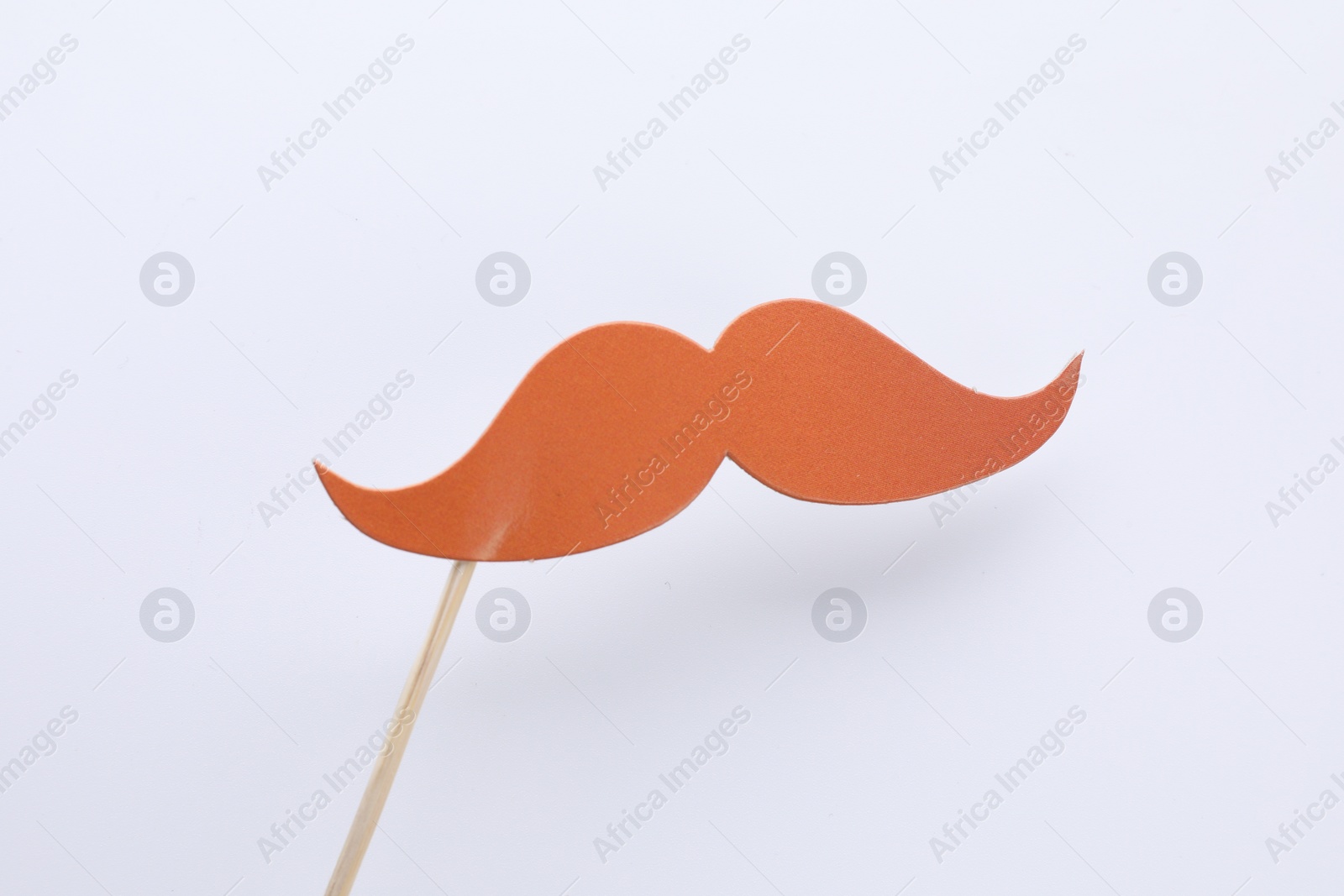 Photo of Fake paper mustache on stick against white background