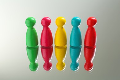 Colorful pawns on white background. Social inclusion concept