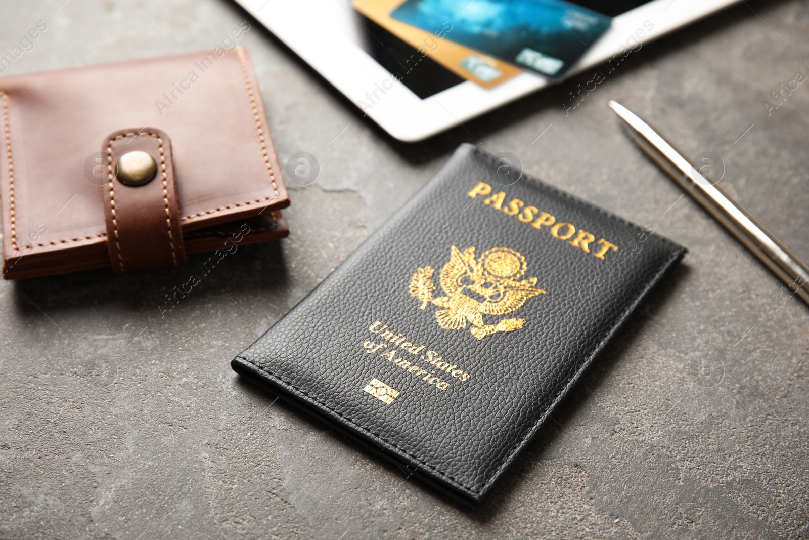 Photo of Composition with passport and wallet on grey table. Travel agency