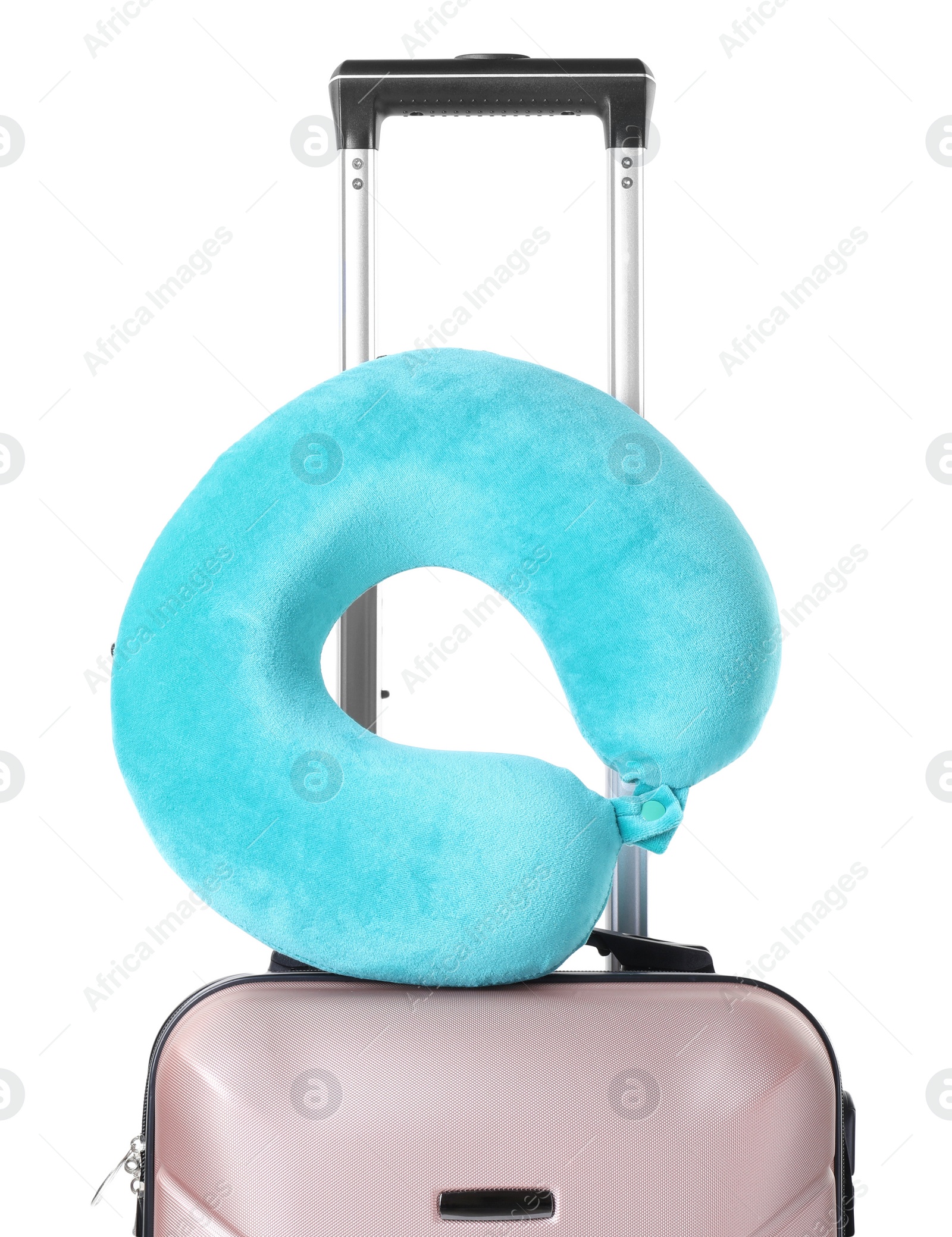 Photo of Light blue travel pillow on suitcase against white background