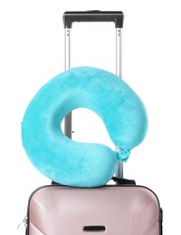 Photo of Light blue travel pillow on suitcase against white background