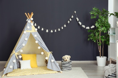 Cozy kids room interior with play tent and toys