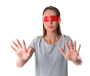 Photo of Young woman wearing red blindfold on white background