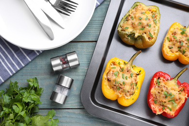 Photo of Flat lay composition with tasty stuffed bell peppers on blue wooden table