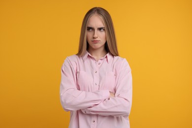 Photo of Portrait of resentful woman on orange background