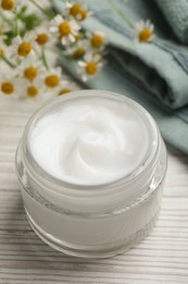 Photo of Jar of organic cream on white wooden table, closeup